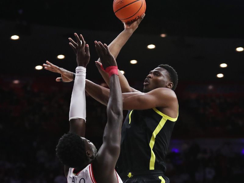 Feb 2, 2023; Tucson, Arizona, USA; Oregon Ducks center N'Faly Dante (1) makes a basket agianst Arizona Wildcats center Oumar Ballo (11) in the first half at McKale Center. Mandatory Credit: Zachary BonDurant-USA TODAY Sports