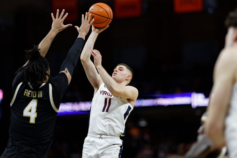 Feb 17, 2024; Charlottesville, Virginia, USA; Virginia Cavaliers guard Isaac McKneely (11) shoots the ball as Wake Forest Demon Deacons forward Efton Reid III (4) defends in the second half at John Paul Jones Arena. Mandatory Credit: Geoff Burke-USA TODAY Sports