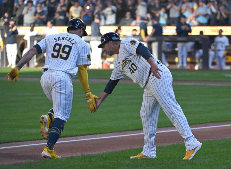 Sep 7, 2024; Milwaukee, Wisconsin, USA; Milwaukee Brewers catcher Gary Sánchez (99) is congratulated by Milwaukee Brewers third base coach Jason Lane (40) as he rounds the bases after hitting a home run against the Colorado Rockies in the first inning at American Family Field. Mandatory Credit: Michael McLoone-Imagn Images