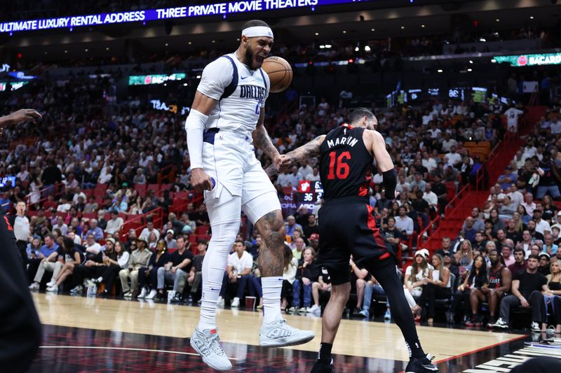 MIAMI, FLORIDA - APRIL 10: Daniel Gafford #21 of the Dallas Mavericks reacts after dunking against Caleb Martin #16 of the Miami Heat during the second quarter of the game at Kaseya Center on April 10, 2024 in Miami, Florida. NOTE TO USER: User expressly acknowledges and agrees that, by downloading and or using this photograph, User is consenting to the terms and conditions of the Getty Images License Agreement. (Photo by Megan Briggs/Getty Images)