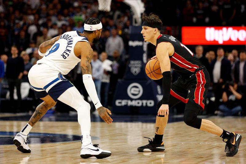 MINNEAPOLIS, MINNESOTA - OCTOBER 28: Tyler Herro #14 of the Miami Heat dribbles the ball while Nickeil Alexander-Walker #9 of the Minnesota Timberwolves defends in the first quarter at Target Center on October 28, 2023 in Minneapolis, Minnesota. NOTE TO USER: User expressly acknowledges and agrees that, by downloading and or using this photograph, User is consenting to the terms and conditions of the Getty Images License Agreement. (Photo by David Berding/Getty Images)