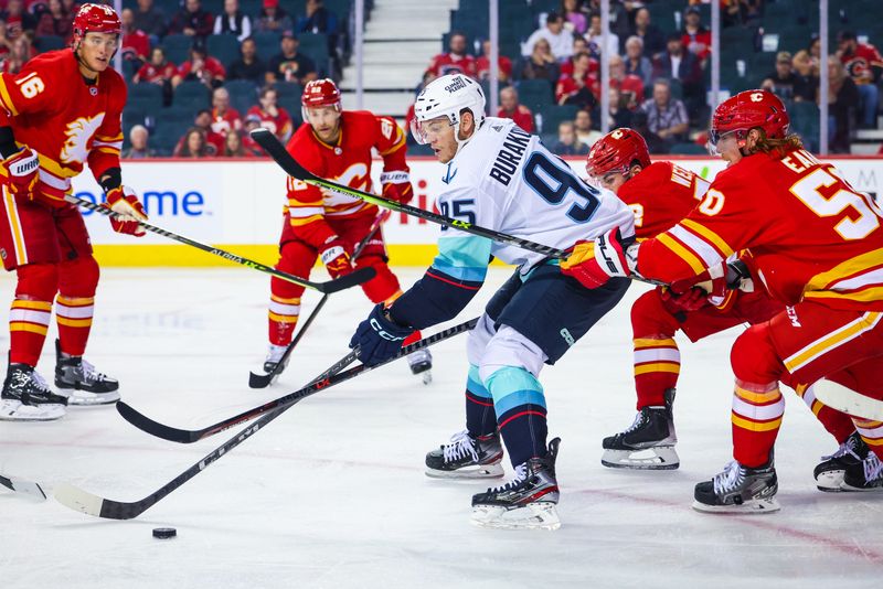 Oct 3, 2022; Calgary, Alberta, CAN; Seattle Kraken left wing Andre Burakovsky (95) battle for the puck against the Calgary Flames during the second period at Scotiabank Saddledome. Mandatory Credit: Sergei Belski-USA TODAY Sports