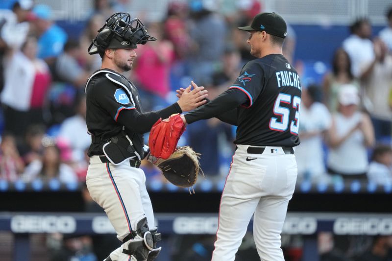 Apr 12, 2025; Miami, Florida, USA;  Miami Marlins pitcher Calvin Faucher (53) is congratulated by catcher Liam Hicks (34) follow a victory against the Washington Nationals at loanDepot Park. Mandatory Credit: Jim Rassol-Imagn Images