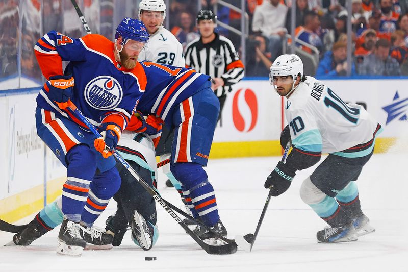 Nov 15, 2023; Edmonton, Alberta, CAN; Edmonton Oilers defensemen Mattias Ekholm (14) and Seattle Kraken forward Matty Beniers (10) look for a loose puck during the second period at Rogers Place. Mandatory Credit: Perry Nelson-USA TODAY Sports