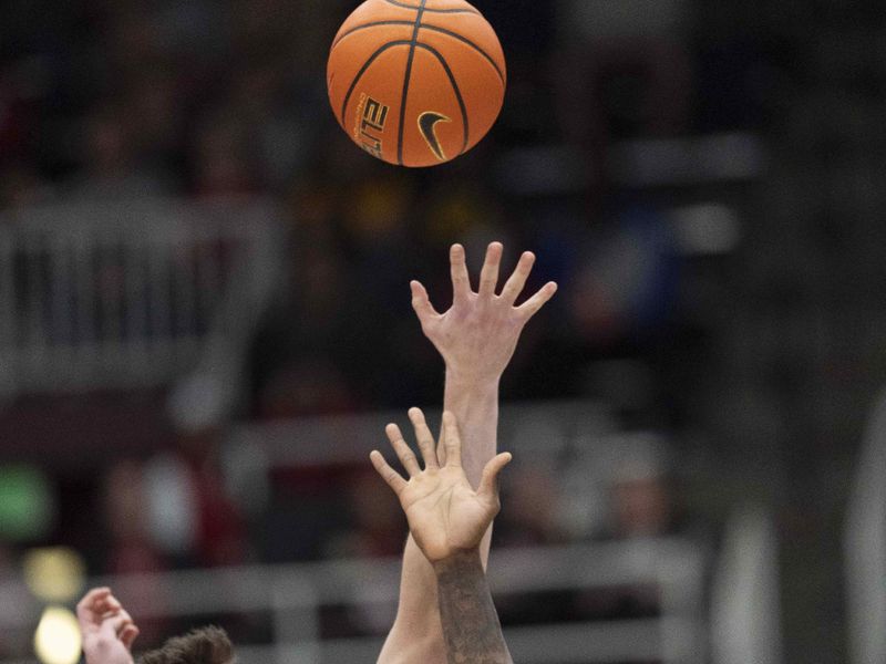 Jan 24, 2026; Stanford, California, USA;  Stanford Cardinal forward AJ Rohosy (4) and California Golden Bears forward Lee Dort (34) jump for the ball during the first half at Maples Pavilion. Mandatory Credit: Stan Szeto-Imagn Images