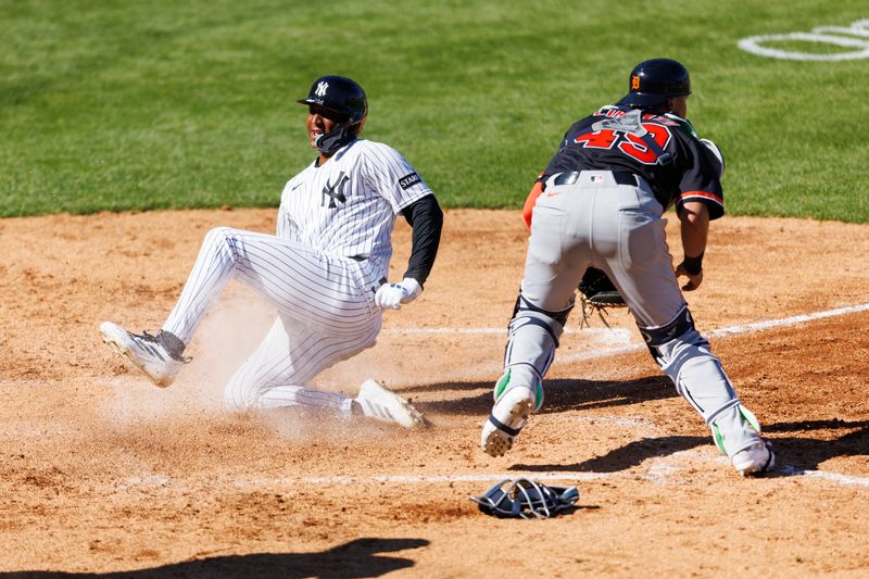 Feb 21, 2026; Tampa, Florida, USA; New York Yankees outfielder Marco Luciano (60) slides into home plate before Detroit Tigers catcher Thayron Liranzo (49) during the sixth inning in a Spring Training game at George M. Steinbrenner Field. Mandatory Credit: Morgan Tencza-Imagn Images