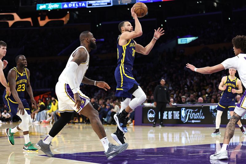 LOS ANGELES, CALIFORNIA - MARCH 16: Stephen Curry #30 of the Golden State Warriors shoots past the defense of LeBron James #23 of the Los Angeles Lakers during the second half of a game at Crypto.com Arena on March 16, 2024 in Los Angeles, California. NOTE TO USER: User expressly acknowledges and agrees that, by downloading and or using this photograph, User is consenting to the terms and conditions of the Getty Images License Agreement. (Photo by Sean M. Haffey/Getty Images)