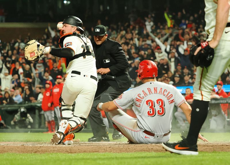 Aug 28, 2023; San Francisco, California, USA; San Francisco Giants catcher Patrick Bailey (14) demonstrates possession after making an out against Cincinnati Reds first baseman Christian Encarnacion-Strand (33) during the seventh inning at Oracle Park. Mandatory Credit: Kelley L Cox-USA TODAY Sports