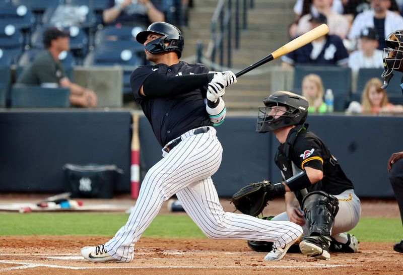 Mar 15, 2024; Tampa, Florida, USA; New York Yankees second baseman Gleyber Torres (25) hits a double against the Pittsburgh Pirates during the first inning at George M. Steinbrenner Field. Mandatory Credit: Kim Klement Neitzel-USA TODAY Sports