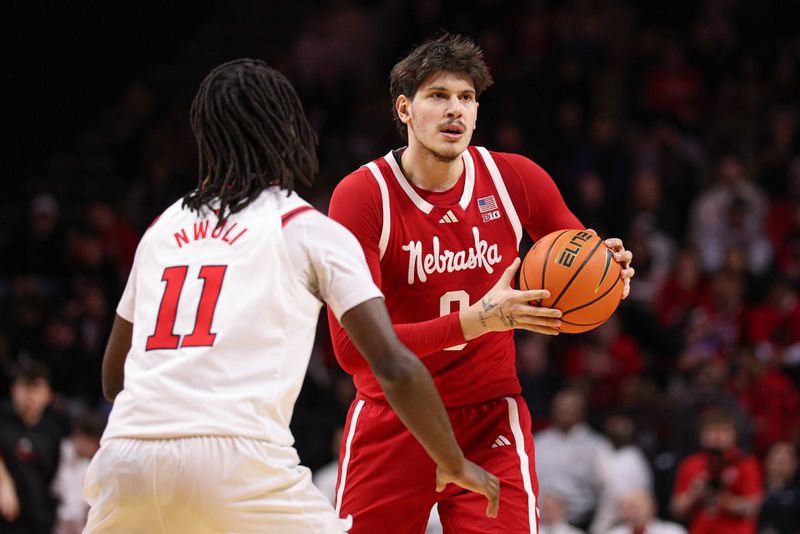 Feb 7, 2026; Piscataway, New Jersey, USA; Nebraska Cornhuskers forward Berke Buyuktuncel (9) looks to pass as Rutgers Scarlet Knights forward Christopher Nwuli (11) defends during the first half at Jersey Mike's Arena. Mandatory Credit: Vincent Carchietta-Imagn Images