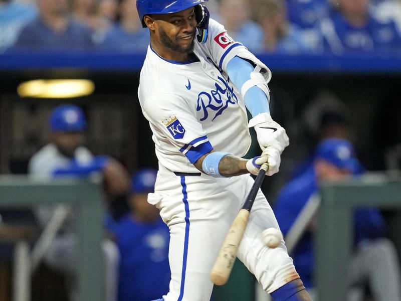 Apr 24, 2024; Kansas City, Missouri, USA; Kansas City Royals third base Maikel Garcia (11) hits a single during the fifth inning against the Toronto Blue Jays at Kauffman Stadium. Mandatory Credit: Jay Biggerstaff-USA TODAY Sports