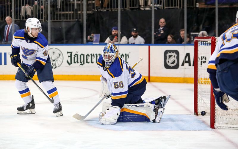 Mar 9, 2024; New York, New York, USA; St. Louis Blues goalie Jordan Binnington (50) tries to stop a shot by New York Rangers center Matt Rempe (73) which was at first called a goal but then overruled after replay during the second period at Madison Square Garden. Mandatory Credit: Danny Wild-USA TODAY Sports