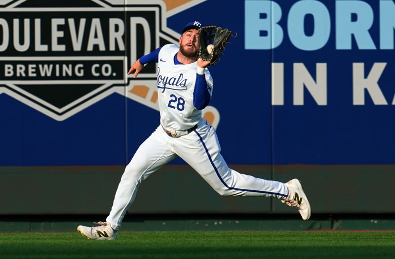 Aug 24, 2024; Kansas City, Missouri, USA; Kansas City Royals center fielder Kyle Isbel (28) catches a fly ball during the second inning against the Philadelphia Phillies at Kauffman Stadium. Mandatory Credit: Jay Biggerstaff-USA TODAY Sports