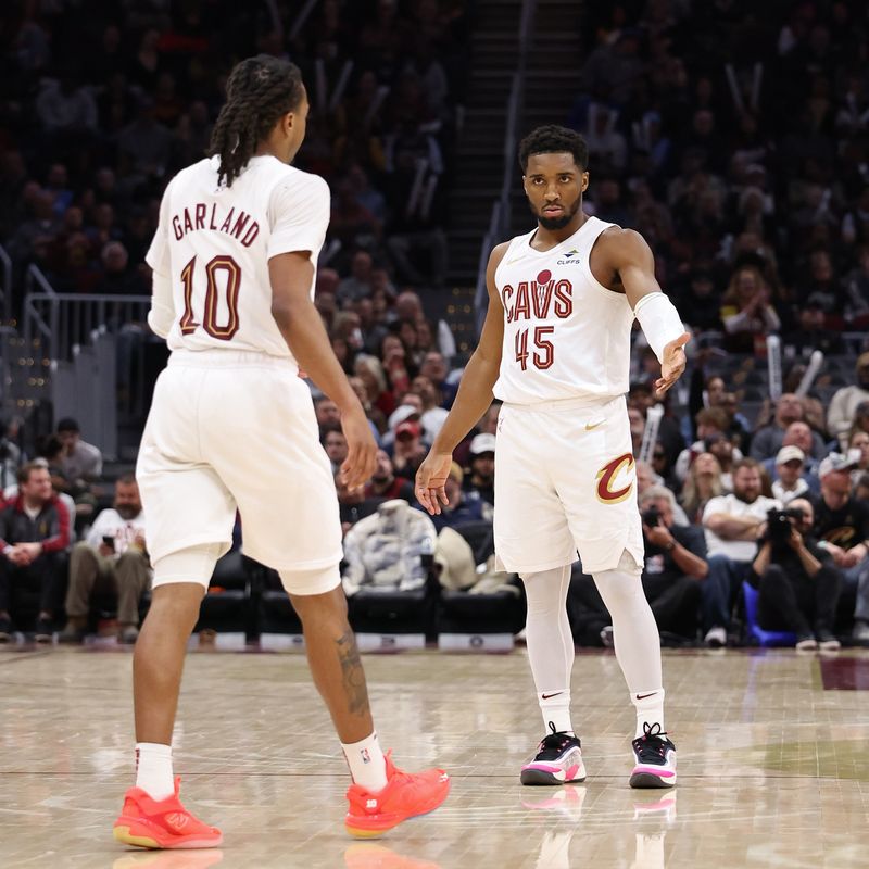 CLEVELAND, OH - JANUARY 27: Donovan Mitchell #45 of the Cleveland Cavaliers high fives Darius Garland #10 during the game against the Detroit Pistons on January 27, 2025 at Rocket Mortgage FieldHouse in Cleveland, Ohio. NOTE TO USER: User expressly acknowledges and agrees that, by downloading and/or using this Photograph, user is consenting to the terms and conditions of the Getty Images License Agreement. Mandatory Copyright Notice: Copyright 2025 NBAE (Photo by  Lauren Leigh Bacho/NBAE via Getty Images)