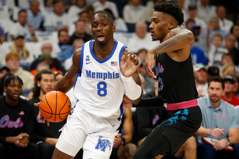 Feb 25, 2024; Memphis, Tennessee, USA; Memphis Tigers forward David Jones (8) drives to the basket as Florida Atlantic Owls guard Brandon Weatherspoon (23) defends during the first half at FedExForum. Mandatory Credit: Petre Thomas-USA TODAY Sports