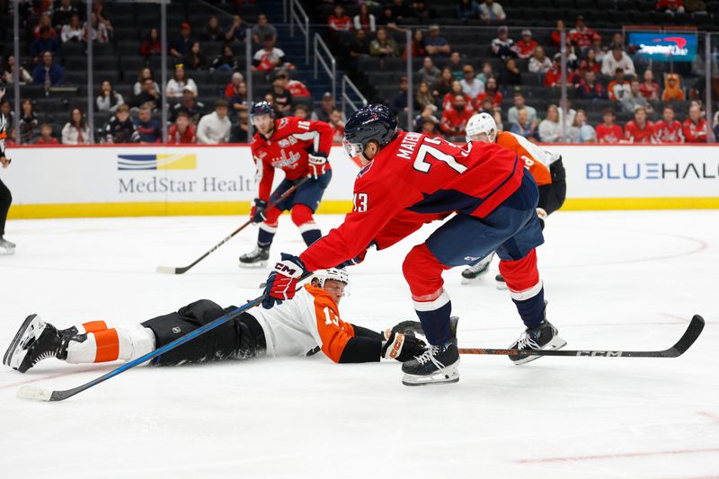 Sep 22, 2024; Washington, District of Columbia, USA; Washington Capitals forward Eriks Mateiko (73) passes the puck to Capitals forward Taylor Raddysh (16) as Philadelphia Flyers defenseman Adam Ginning (13)  defends in the third period at Capital One Arena. Mandatory Credit: Geoff Burke-Imagn Images