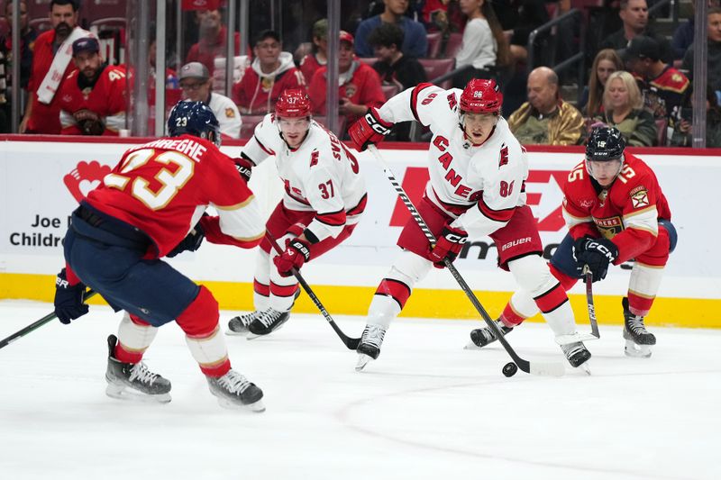 Nov 10, 2023; Sunrise, Florida, USA; Carolina Hurricanes left wing Teuvo Teravainen (86) plays the puck in front of Florida Panthers center Anton Lundell (15) during the first period at Amerant Bank Arena. Mandatory Credit: Jasen Vinlove-USA TODAY Sports