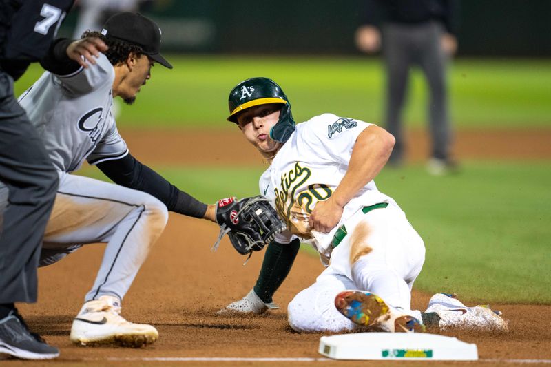 Aug 5, 2024; Oakland, California, USA;  Oakland Athletics second baseman Zack Gelof (20) slides in safely against Chicago White Sox third baseman Miguel Vargas (20) during the eighth inning at Oakland-Alameda County Coliseum. Mandatory Credit: Neville E. Guard-USA TODAY Sports