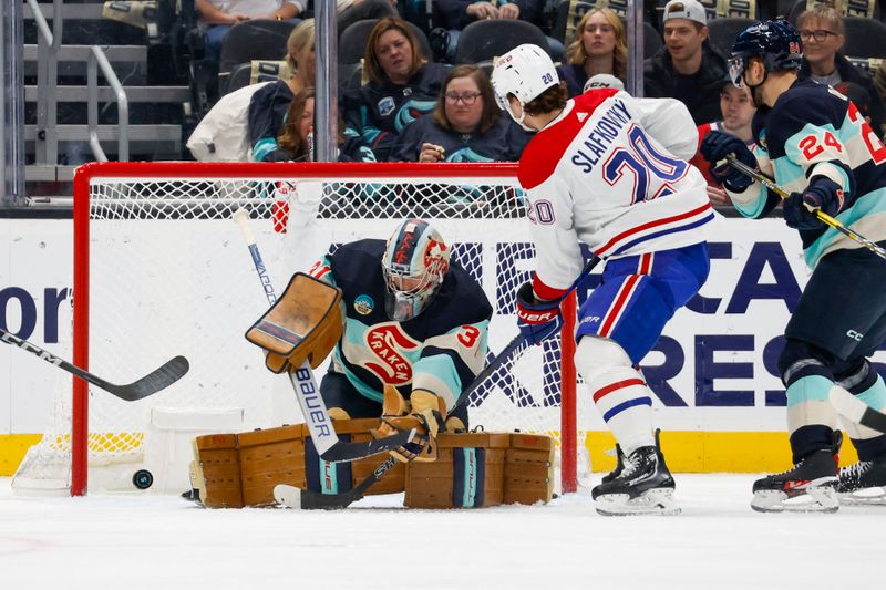 Mar 24, 2024; Seattle, Washington, USA; Montreal Canadiens left wing Juraj Slafkovsky (20) scores a goal against Seattle Kraken goaltender Philipp Grubauer (31) during the first period at Climate Pledge Arena. Mandatory Credit: Joe Nicholson-USA TODAY Sports