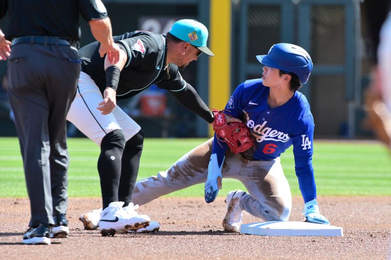 Feb 25, 2026; Salt River Pima-Maricopa, Arizona, USA; Los Angeles Dodgers second baseman Hyeseong Kim (6) steals second base on Arizona Diamondbacks second baseman Ildemaro Vargas (6) in the first inning at Salt River Fields at Talking Stick. Mandatory Credit: Matt Kartozian-Imagn Images