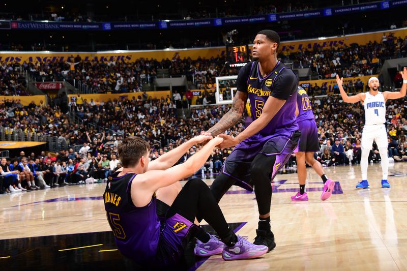 LOS ANGELES, CA - NOVEMBER 21: Cam Reddish #5 of the Los Angeles Lakers helps up Austin Reaves #15 of the Los Angeles Lakers during the game against the Orlando Magic on November 21, 2024 at Crypto.Com Arena in Los Angeles, California. NOTE TO USER: User expressly acknowledges and agrees that, by downloading and/or using this Photograph, user is consenting to the terms and conditions of the Getty Images License Agreement. Mandatory Copyright Notice: Copyright 2024 NBAE (Photo by Adam Pantozzi/NBAE via Getty Images)