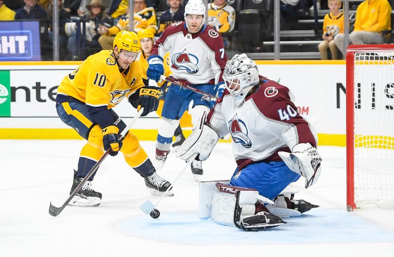 Nov 20, 2023; Nashville, Tennessee, USA; Colorado Avalanche goaltender Alexandar Georgiev (40) blocks the shot of Nashville Predators center Colton Sissons (10) during the first period at Bridgestone Arena. Mandatory Credit: Steve Roberts-USA TODAY Sports