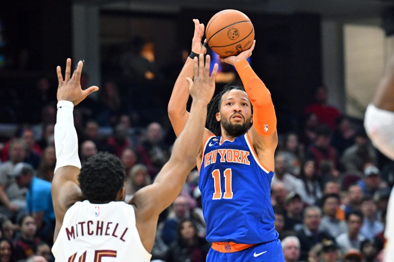 CLEVELAND, OHIO - MARCH 31: Jalen Brunson #11 of the New York Knicks shoots over Donovan Mitchell #45 of the Cleveland Cavaliers during the second quarter at Rocket Mortgage Fieldhouse on March 31, 2023 in Cleveland, Ohio. NOTE TO USER: User expressly acknowledges and agrees that, by downloading and or using this photograph, User is consenting to the terms and conditions of the Getty Images License Agreement. (Photo by Jason Miller/Getty Images)