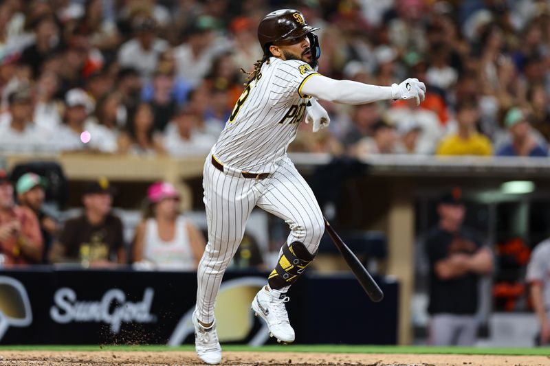 Sep 7, 2024; San Diego, California, USA; San Diego Padres pinch hitter Fernando Tatis Jr. (23) hits a double against the San Francisco Giants during the ninth inning at Petco Park. Mandatory Credit: Chadd Cady-Imagn Images