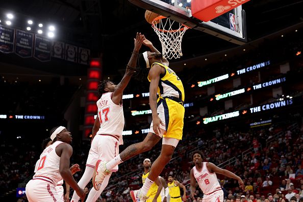 HOUSTON, TEXAS - DECEMBER 26: Tari Eason #17 of the Houston Rockets blocks a shot by Isaiah Jackson #22 of the Indiana Pacers in the first half at Toyota Center on December 26, 2023 in Houston, Texas.  NOTE TO USER: User expressly acknowledges and agrees that, by downloading and or using this photograph, User is consenting to the terms and conditions of the Getty Images License Agreement. (Photo by Tim Warner/Getty Images)