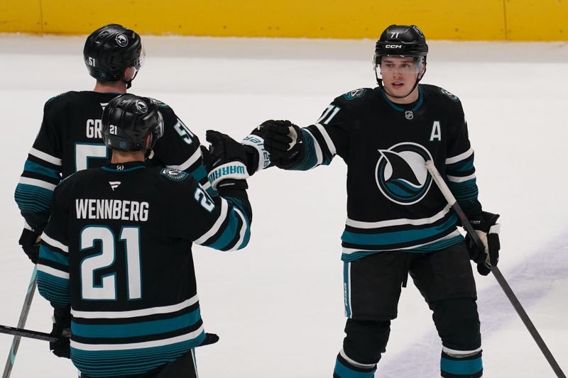 Jan 6, 2026; San Jose, California, USA;  San Jose Sharks center Macklin Celebrini (71) is congratulated by center Alexander Wennberg (21) and right wing Collin Graf (51) after scoring a goal against the Columbus Blue Jackets in the third period at SAP Center at San Jose. Mandatory Credit: David Gonzales-Imagn Images