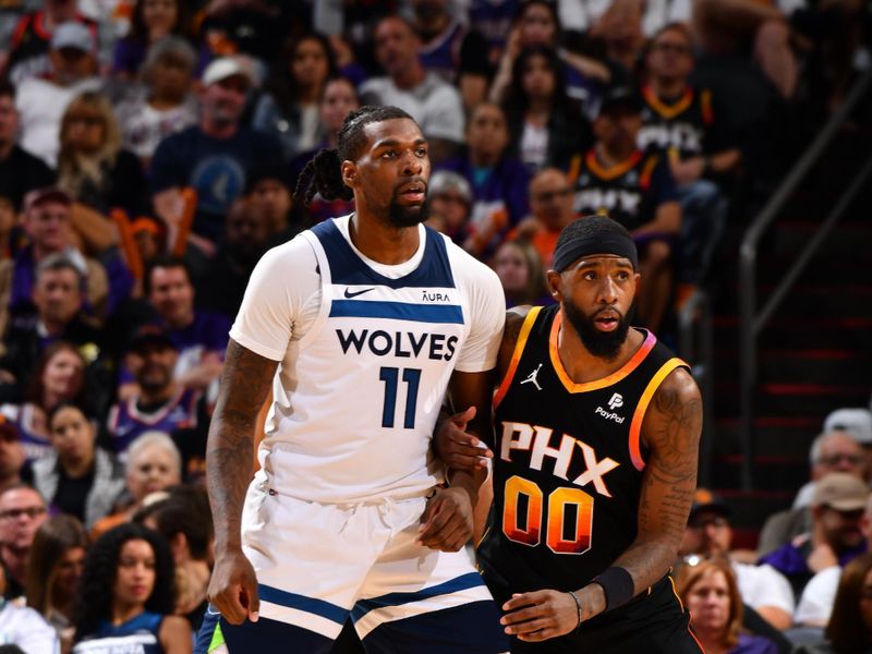 PHOENIX, AZ - APRIL 26:  Naz Reid #11 of the Minnesota Timberwolves plays defense against Royce O'Neale #00 of the Phoenix Suns during Round 1 Game 3 of the 2024 NBA Playoffs on April 26, 2024 at Footprint Center in Phoenix, Arizona. NOTE TO USER: User expressly acknowledges and agrees that, by downloading and or using this photograph, user is consenting to the terms and conditions of the Getty Images License Agreement. Mandatory Copyright Notice: Copyright 2024 NBAE (Photo by Barry Gossage/NBAE via Getty Images)