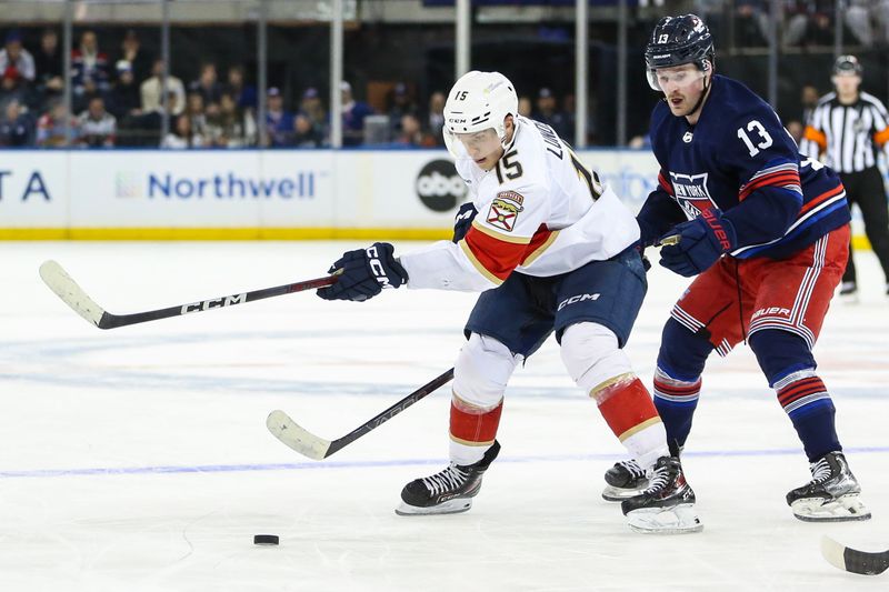 Mar 23, 2024; New York, New York, USA; Florida Panthers center Anton Lundell (15) and New York Rangers left wing Alexis Lafreniere (13) battle for control of the puck in the third period at Madison Square Garden. Mandatory Credit: Wendell Cruz-USA TODAY Sports