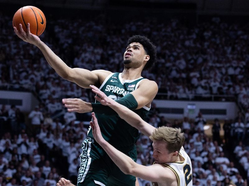 Jan 29, 2023; West Lafayette, Indiana, USA; Michigan State Spartans forward Malik Hall (25)  shoots the ball while  Purdue Boilermakers guard Fletcher Loyer (2) defends in the first half at Mackey Arena. Mandatory Credit: Trevor Ruszkowski-USA TODAY Sports