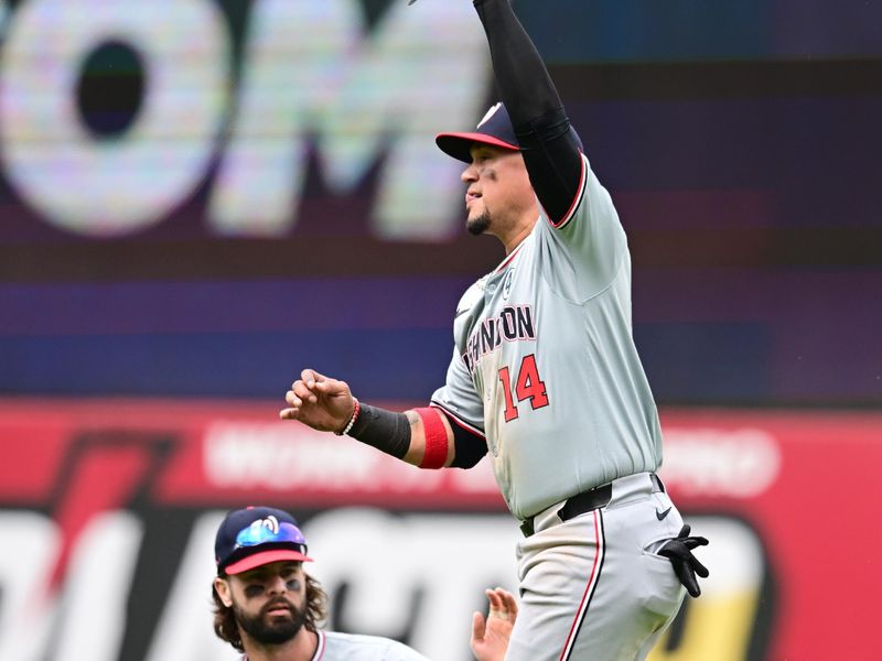 Jun 2, 2024; Cleveland, Ohio, USA; Washington Nationals shortstop Ildemaro Vargas (14) catches a ball hit by Cleveland Guardians first baseman Josh Naylor (not pictured) as left fielder Jesse Winker (6) slides in during the seventh inning at Progressive Field. Mandatory Credit: Ken Blaze-USA TODAY Sports