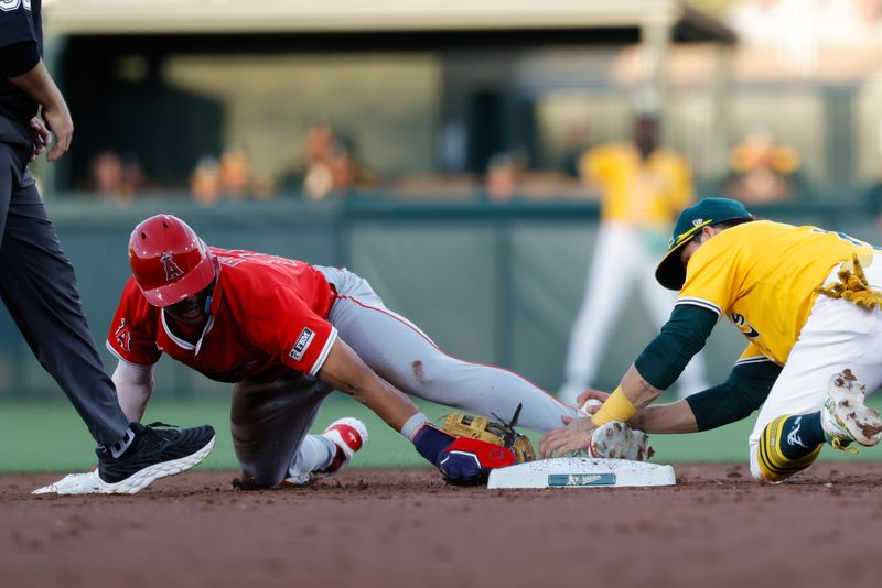 May 20, 2025; West Sacramento, California, USA; Los Angeles Angels pitcher Yusei Kikuchi (16) avoids the tag by Athletics second baseman Luis Urías (17) to steal second base during the third inning at Sutter Health Park. Mandatory Credit: Sergio Estrada-Imagn Images