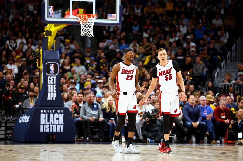 DENVER, COLORADO - FEBRUARY 29: Jimmy Butler #22 and Duncan Robinson #55 of the Miami Heat talk against the Denver Nuggets at Ball Arena on February 29, 2024 in Denver, Colorado. NOTE TO USER: User expressly acknowledges and agrees that, by downloading and/or using this Photograph, user is consenting to the terms and conditions of the Getty Images License Agreement. (Photo by Jamie Schwaberow/Getty Images)