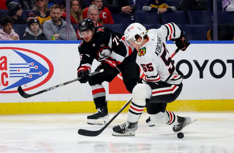 Jan 18, 2024; Buffalo, New York, USA;  Chicago Blackhawks defenseman Kevin Korchinski (55) tries to block a pass by Buffalo Sabres defenseman Connor Clifton (75) during the second period at KeyBank Center. Mandatory Credit: Timothy T. Ludwig-USA TODAY Sports