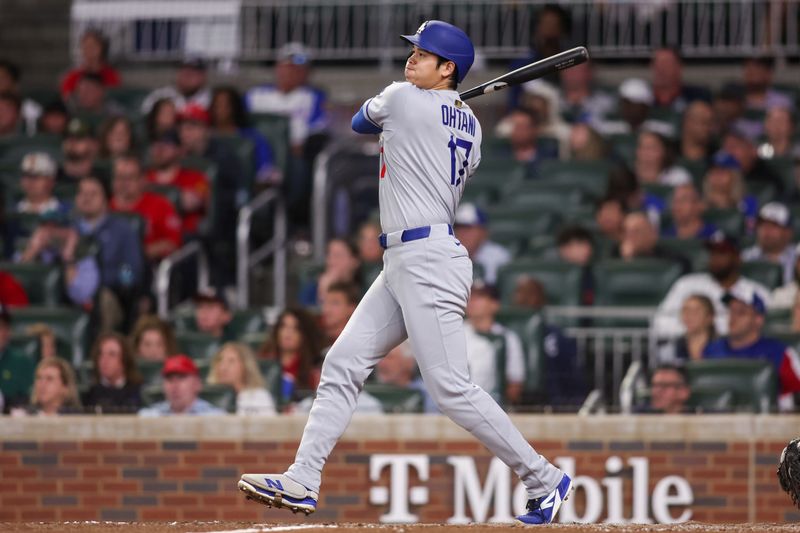 May 4, 2025; Atlanta, Georgia, USA; Los Angeles Dodgers designated hitter Shohei Ohtani (17) hits a double against the Atlanta Braves in the seventh inning at Truist Park. Mandatory Credit: Brett Davis-Imagn Images