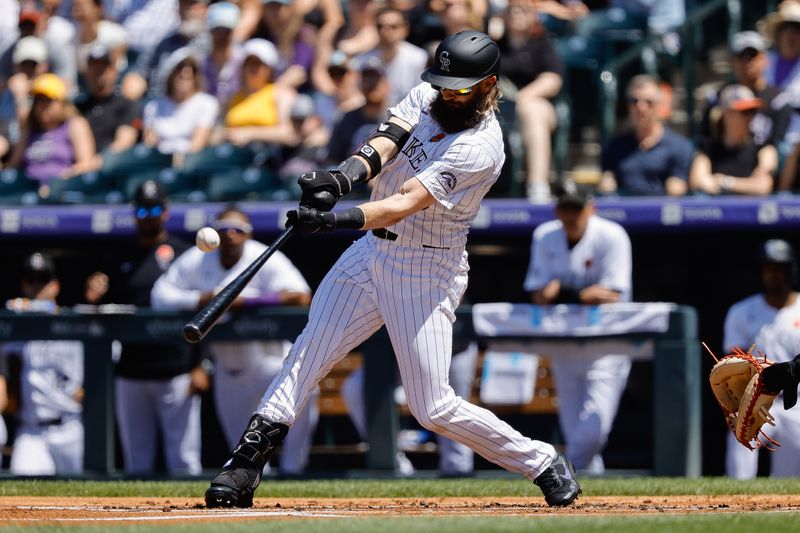 May 27, 2024; Denver, Colorado, USA; Colorado Rockies right fielder Charlie Blackmon (19) hits a double in the first inning against the Cleveland Guardians at Coors Field. Mandatory Credit: Isaiah J. Downing-USA TODAY Sports