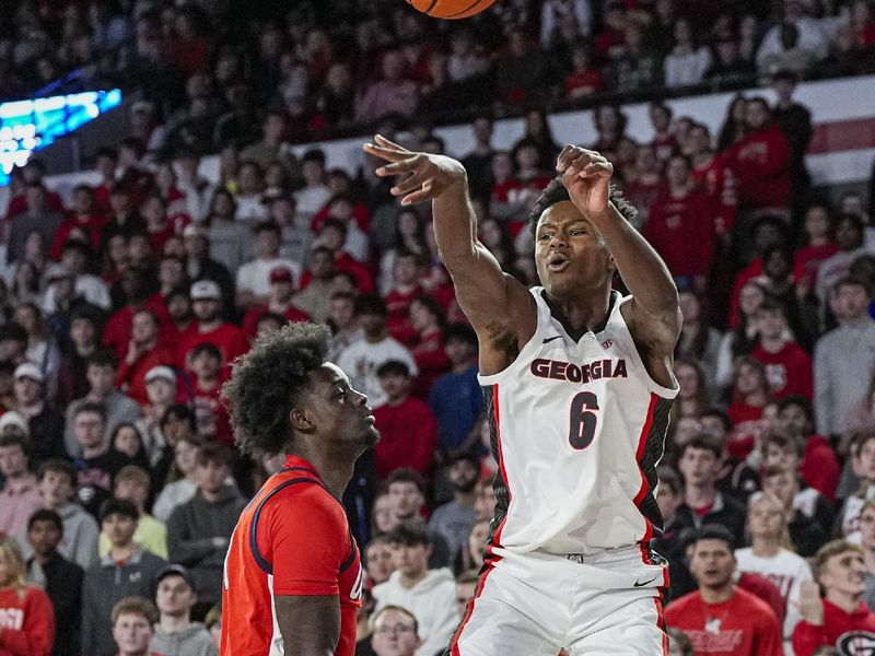 Jan 14, 2026; Athens, Georgia, USA; Georgia Bulldogs forward Kanon Catchings (6) passes over Mississippi Rebels forward Corey Chest (1) during the first half at Stegeman Coliseum. Mandatory Credit: Dale Zanine-Imagn Images