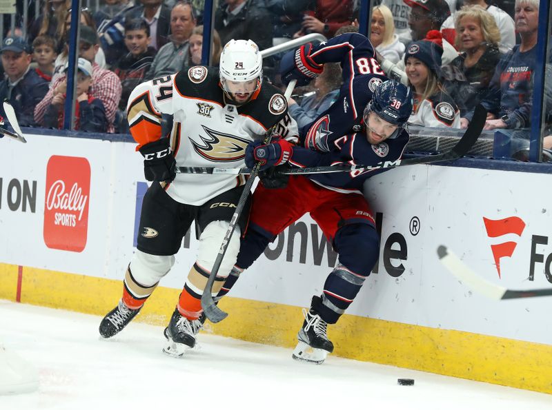 Oct 24, 2023; Columbus, Ohio, USA; Anaheim Ducks center Benoit-Olivier Groulx (24) and Columbus Blue Jackets center Boone Jenner (38) go for the loose puck during the second period at Nationwide Arena. Mandatory Credit: Joseph Maiorana-USA TODAY Sports