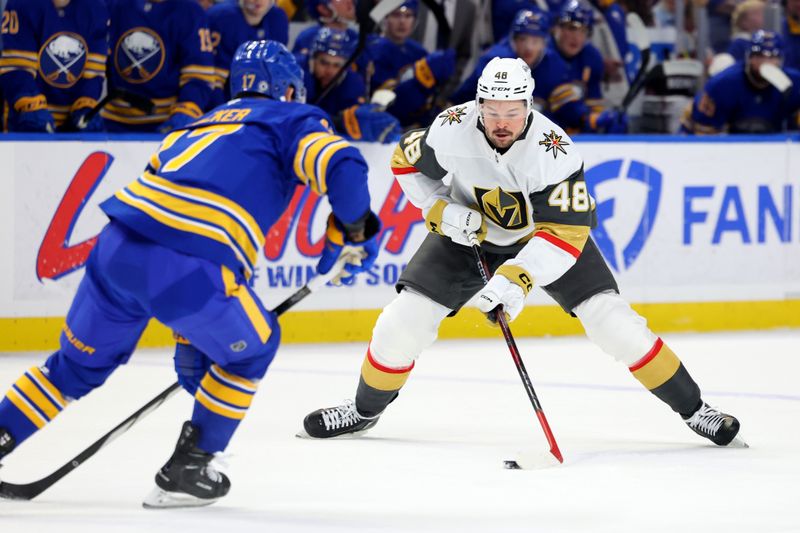 Mar 15, 2025; Buffalo, New York, USA;  Vegas Golden Knights center Tomas Hertl (48) controls the puck as Buffalo Sabres left wing Jason Zucker (17) defends during the first period at KeyBank Center. Mandatory Credit: Timothy T. Ludwig-Imagn Images