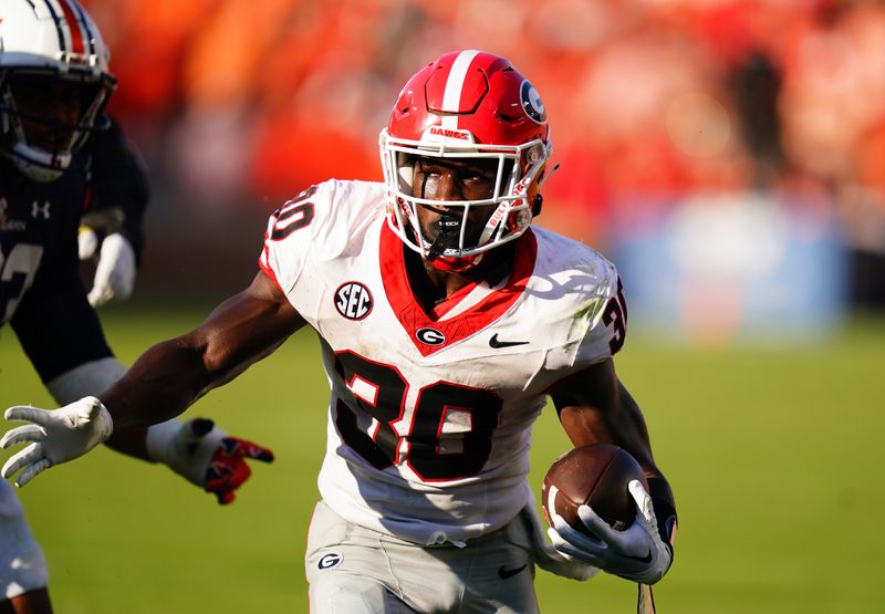 Sep 30, 2023; Auburn, Alabama, USA; Georgia Bulldogs running back Daijun Edwards (30) carries for a touchdown against the Auburn Tigers during the third quarter at Jordan-Hare Stadium. Mandatory Credit: John David Mercer-USA TODAY Sports