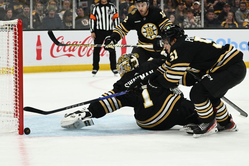 Oct 14, 2023; Boston, Massachusetts, USA; Boston Bruins center Matthew Poitras (51) and goaltender Jeremy Swayman (1) make a save during the third period of a game against the Nashville Predators at the TD Garden. Mandatory Credit: Brian Fluharty-USA TODAY Sports