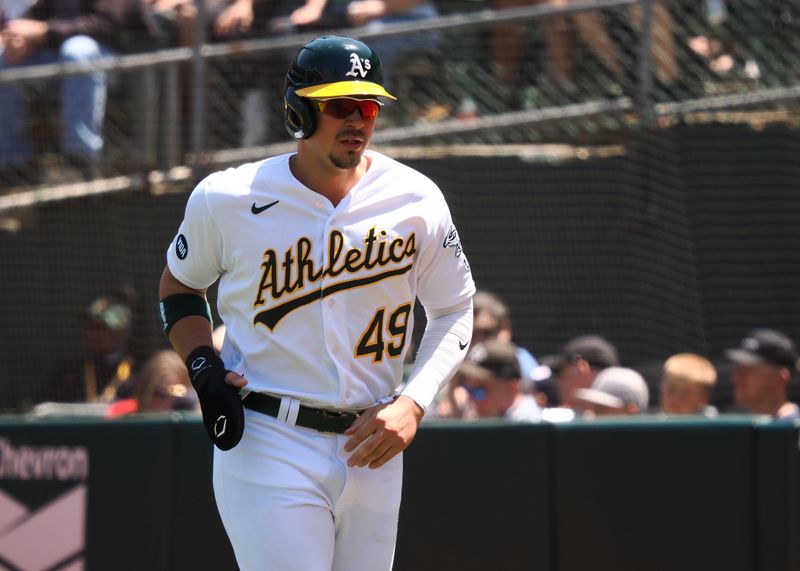 May 31, 2023; Oakland, California, USA; Oakland Athletics first baseman Ryan Noda (49) jogs towards the dugout after being batted in during the sixth inning against the Atlanta Braves at Oakland-Alameda County Coliseum. Mandatory Credit: Kelley L Cox-USA TODAY Sports