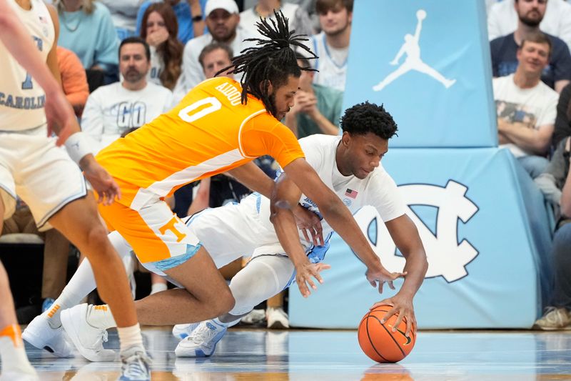 Nov 29, 2023; Chapel Hill, North Carolina, USA; North Carolina Tar Heels forward Jalen Washington (13) and Tennessee Volunteers forward Jonas Aidoo (0) fight for the ball in the second half at Dean E. Smith Center. Mandatory Credit: Bob Donnan-USA TODAY Sports