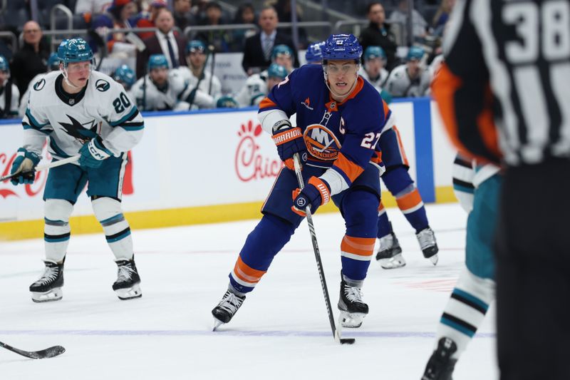 Jan 18, 2025; Elmont, New York, USA; New York Islanders left wing Anders Lee (27) controls the puck up ice against the San Jose Sharks during the second period at UBS Arena. Mandatory Credit: Thomas Salus-Imagn Images