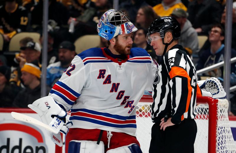 Nov 22, 2023; Pittsburgh, Pennsylvania, USA; New York Rangers goaltender Jonathan Quick (32) talks with referee Graham Skilliter (24) against the Pittsburgh Penguins at PPG Paints Arena. Mandatory Credit: Charles LeClaire-USA TODAY Sports