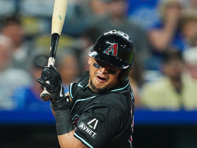 Jul 22, 2024; Kansas City, Missouri, USA; Arizona Diamondbacks catcher Gabriel Moreno (14) is hit but a pitch during the seventh inning against the Kansas City Royals at Kauffman Stadium. Mandatory Credit: Jay Biggerstaff-USA TODAY Sports