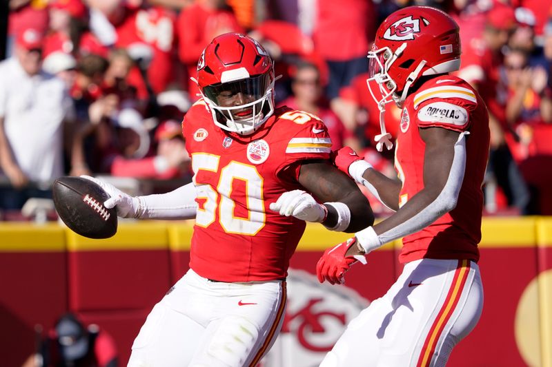 Kansas City Chiefs linebacker Willie Gay (50) is congratulated by Joshua Williams after recovering a fumble during the first half of an NFL football game against the Chicago Bears Sunday, Sept. 24, 2023, in Kansas City, Mo. (AP Photo/Ed Zurga)